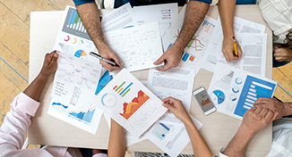 Image of image of a group of colleagues collating data