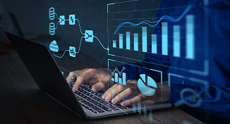 Image of a man using a laptop with digital graphs flowing out of the screen