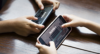 Image of two people competing on mobile games