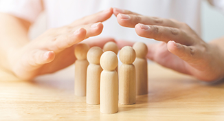 Image of Human hands over pegs on table