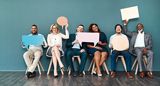 Image of Group of colleagues holding empty speech marks signs