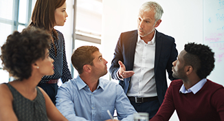 Image of Group of colleagues listening to one person