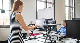 Image of A colleague using multiple screens