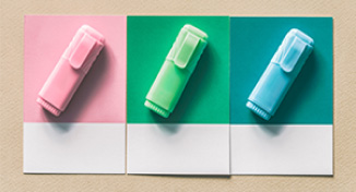 Image of Three different coloured highlighters on three notebooks