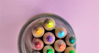 Image of Different coloured pencils in a pencil holder 